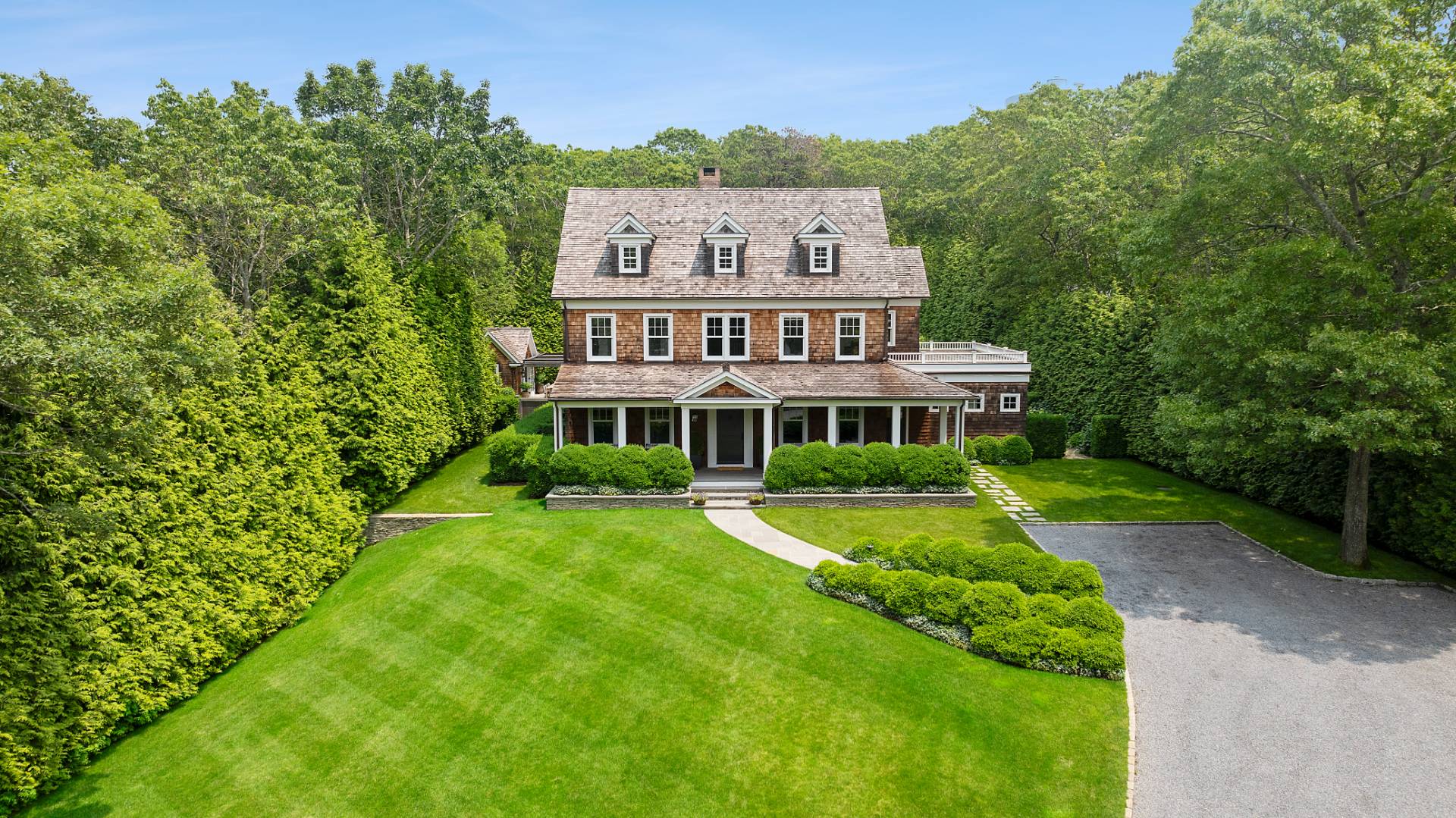 23 Wooded Path Sag Harbor, NY 11963 - Photo 2 of 25 a view of a big house with a big yard and large trees