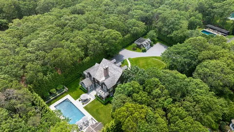an aerial view of a house with a yard