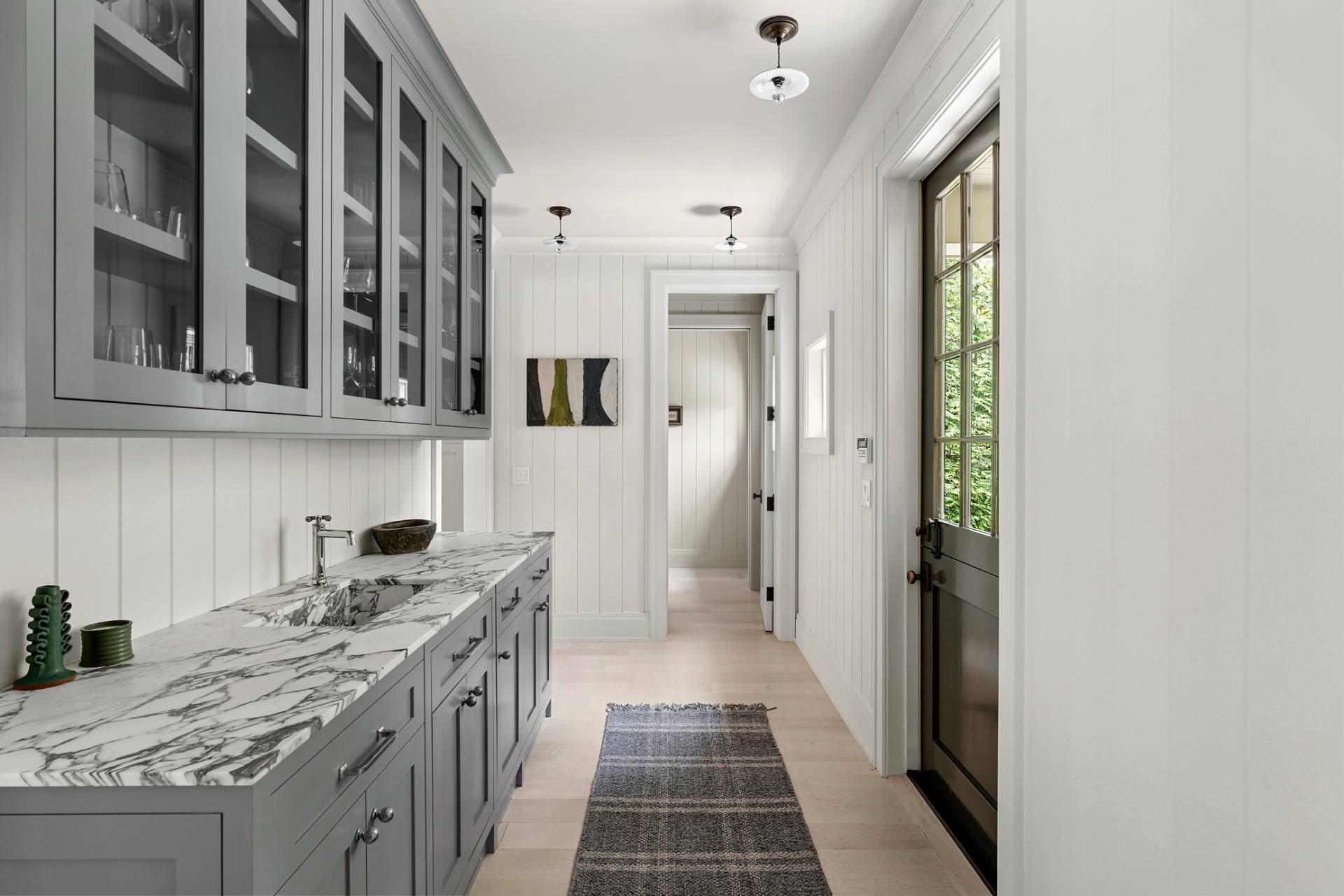 23 Wooded Path Sag Harbor, NY 11963 - Photo 7 of 25 a kitchen with a sink stove and cabinets