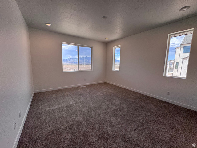 2613 Scarlet Road, Unit 258 Eagle Mountain, UT 84005 - Photo 14 of 33 Carpeted room featuring multiple windows with mountain and neighborhood scenery