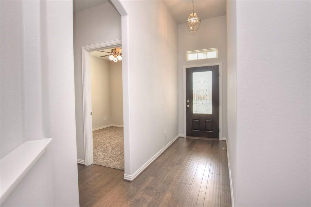 704 Bonnet Boulevard Georgetown, TX 78628 - Photo 5 of 40 Front door leads to a foyer to the right of the hallway are the 2 secondary bedrooms with a bathroom in between and a walk in cloak closet