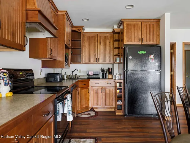 a kitchen with stainless steel appliances granite countertop a refrigerator a stove and a sink
