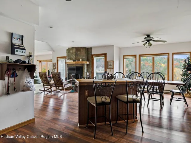 a view of a a dining room with furniture window and wooden floor
