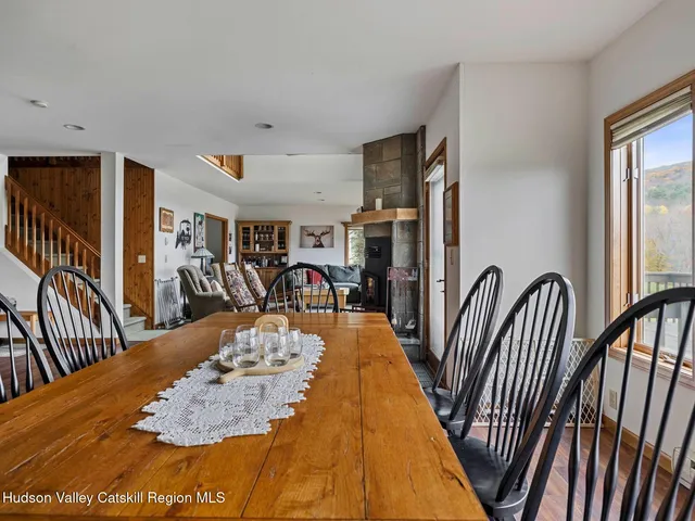 a very nice looking dining room with kitchen countertops and wooden floor