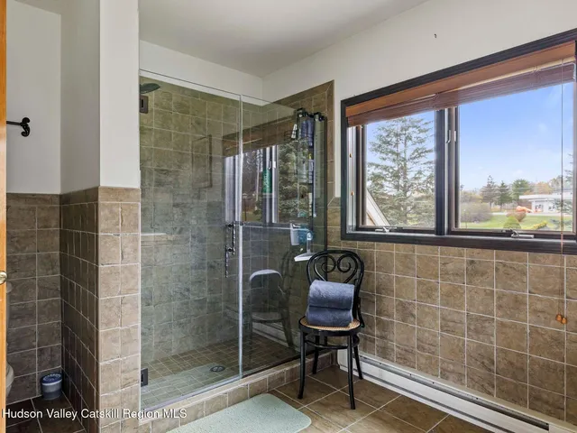 a view of a hallway with wooden floor and entryway
