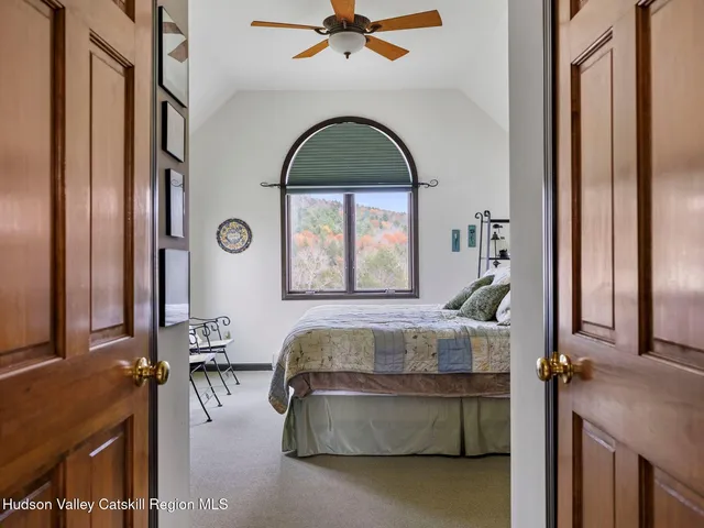 a bedroom with a bed a window and dresser