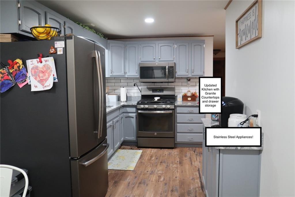 271 Medical Center Road Chicora, PA 16025 - Photo 5 of 18 a kitchen with a refrigerator and a stove top oven