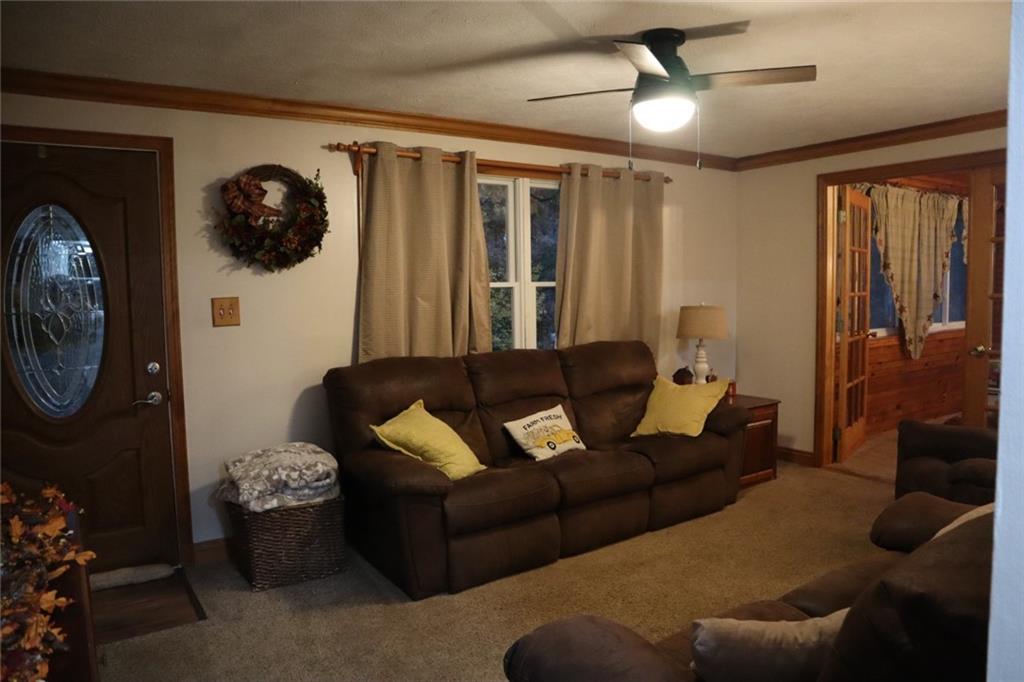 271 Medical Center Road Chicora, PA 16025 - Photo 10 of 18 a living room with furniture a chandelier fan and a window