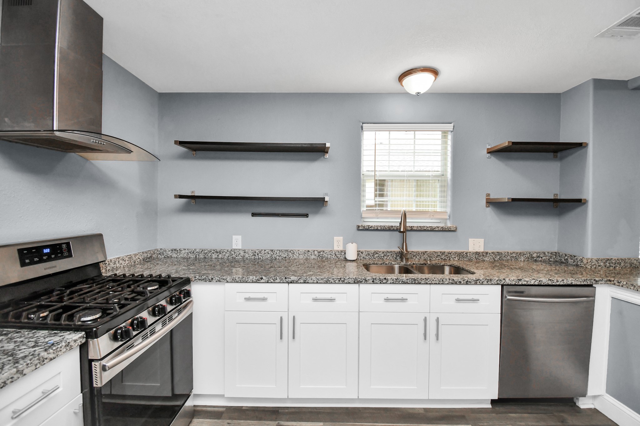 3217 Michigan Street Baytown, TX 77520 - Photo 12 of 37 a kitchen with stainless steel appliances granite countertop a sink stove and cabinets