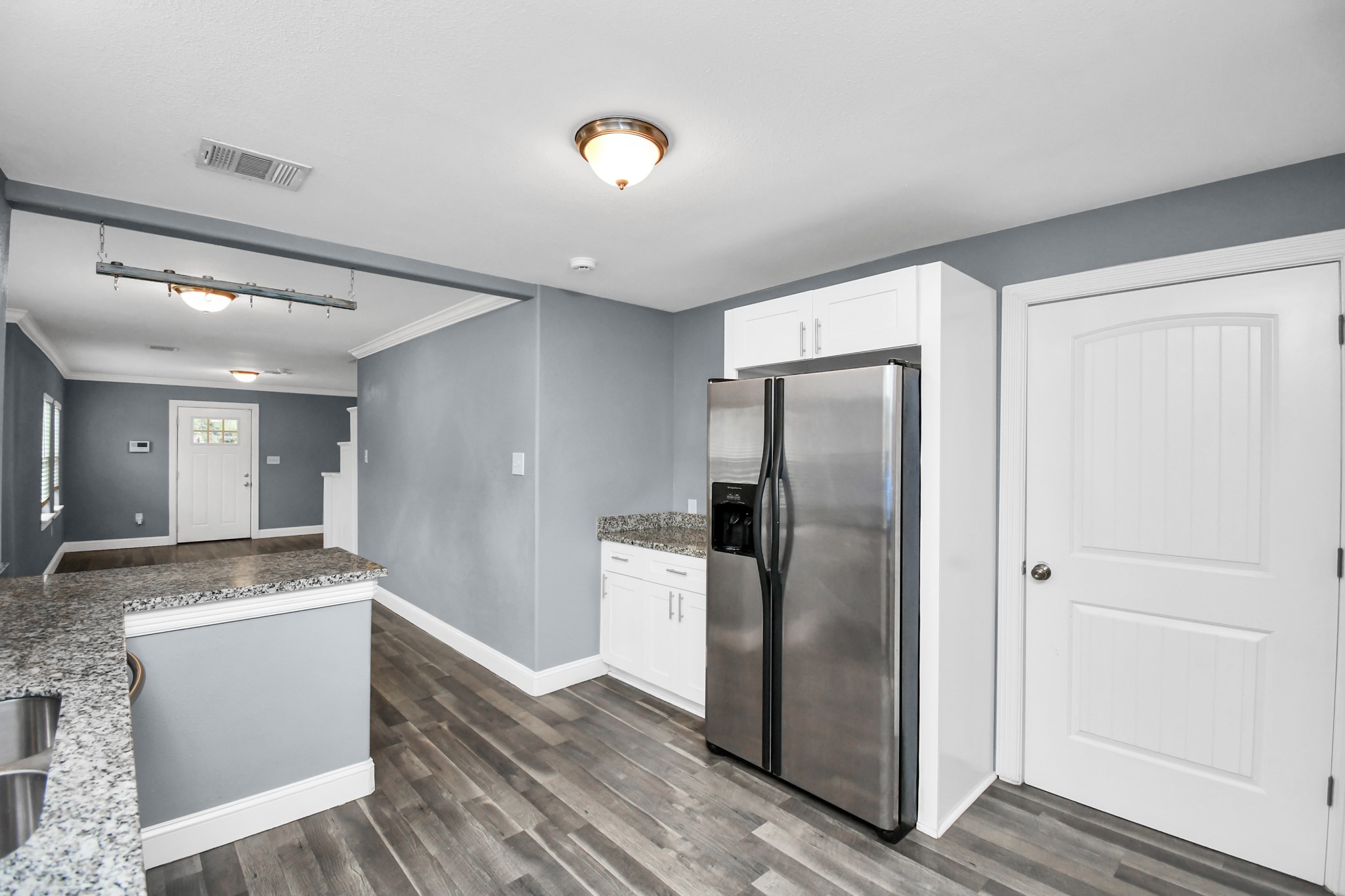 3217 Michigan Street Baytown, TX 77520 - Photo 15 of 37 a view of a refrigerator in kitchen and wooden floor