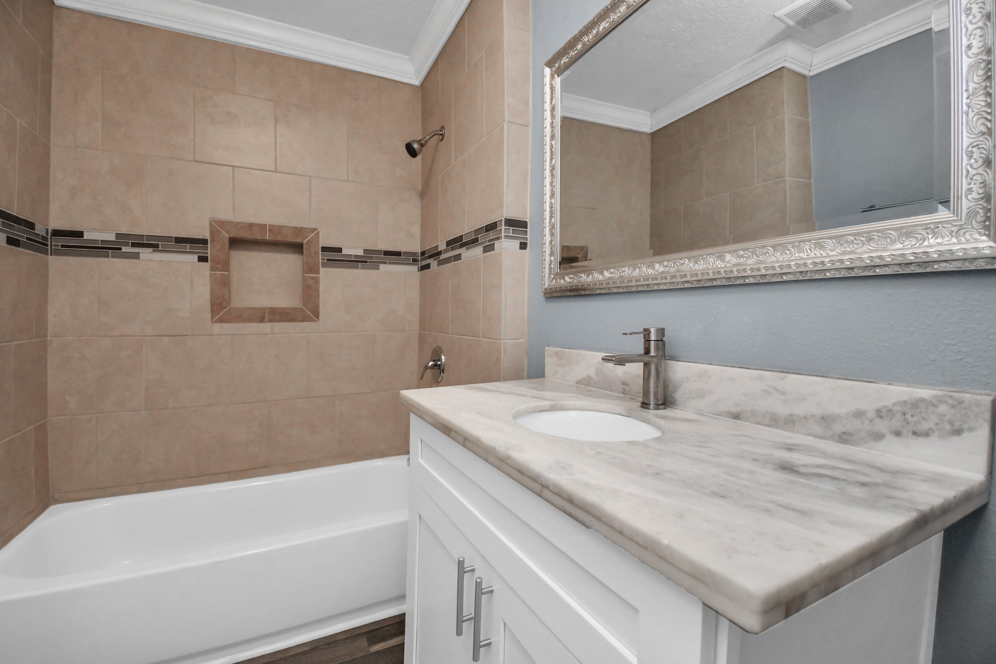 3217 Michigan Street Baytown, TX 77520 - Photo 20 of 37 a bathroom with a granite countertop sink and a bathtub