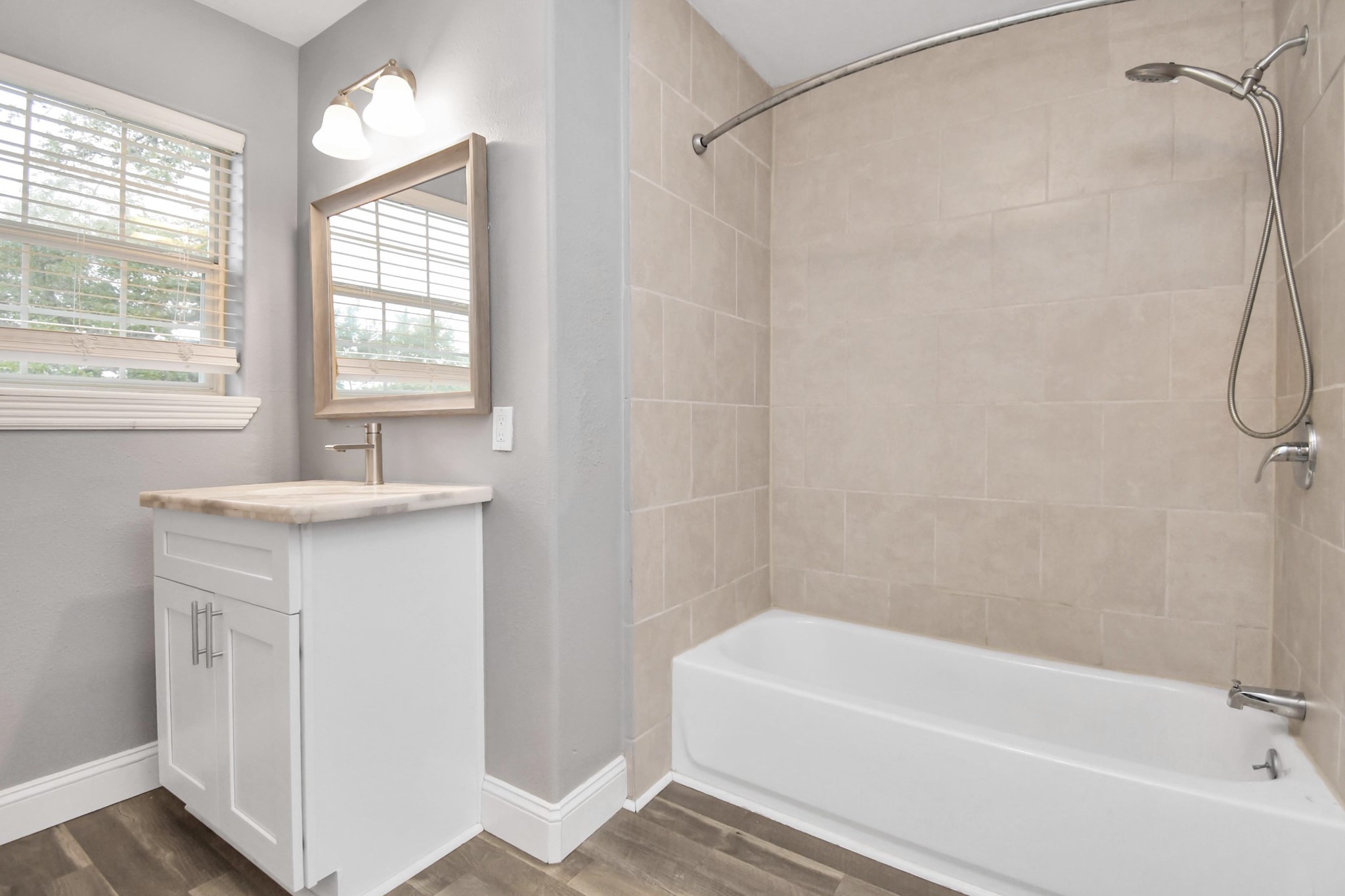 3217 Michigan Street Baytown, TX 77520 - Photo 29 of 37 a bathroom with a sink a mirror and a bathtub