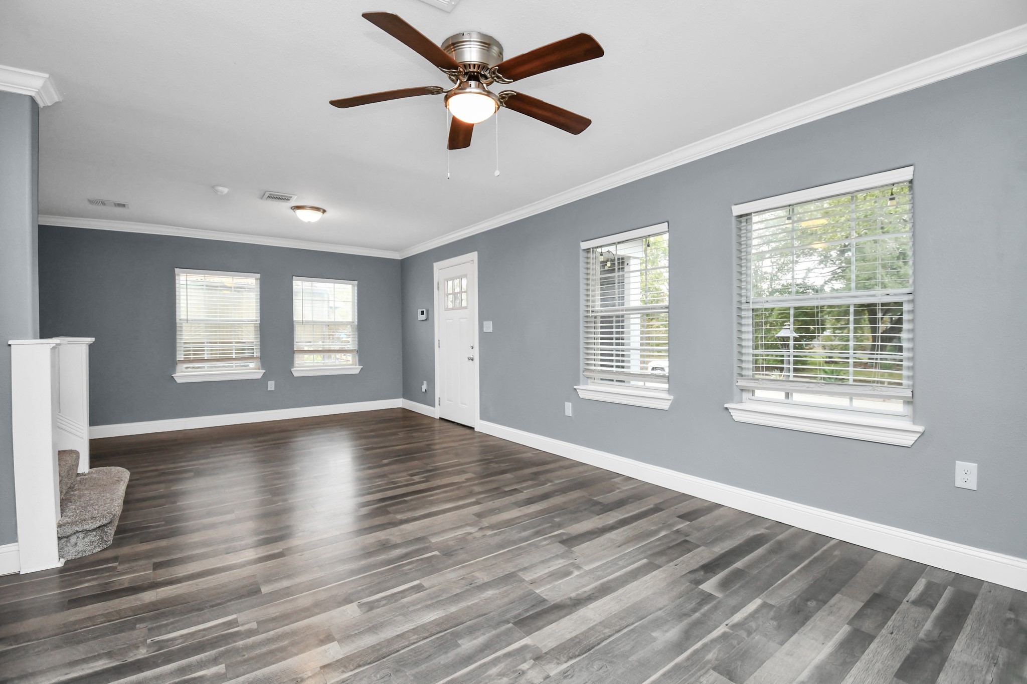 3217 Michigan Street Baytown, TX 77520 - Photo 6 of 37 a view of an empty room with wooden floor and a window