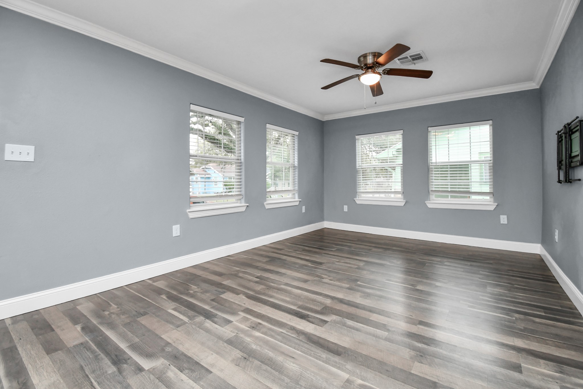 3217 Michigan Street Baytown, TX 77520 - Photo 7 of 37 a view of an empty room with wooden floor and a window