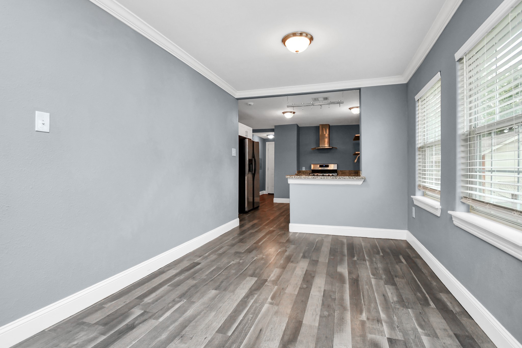 3217 Michigan Street Baytown, TX 77520 - Photo 9 of 37 a view of a big room with wooden floor and windows