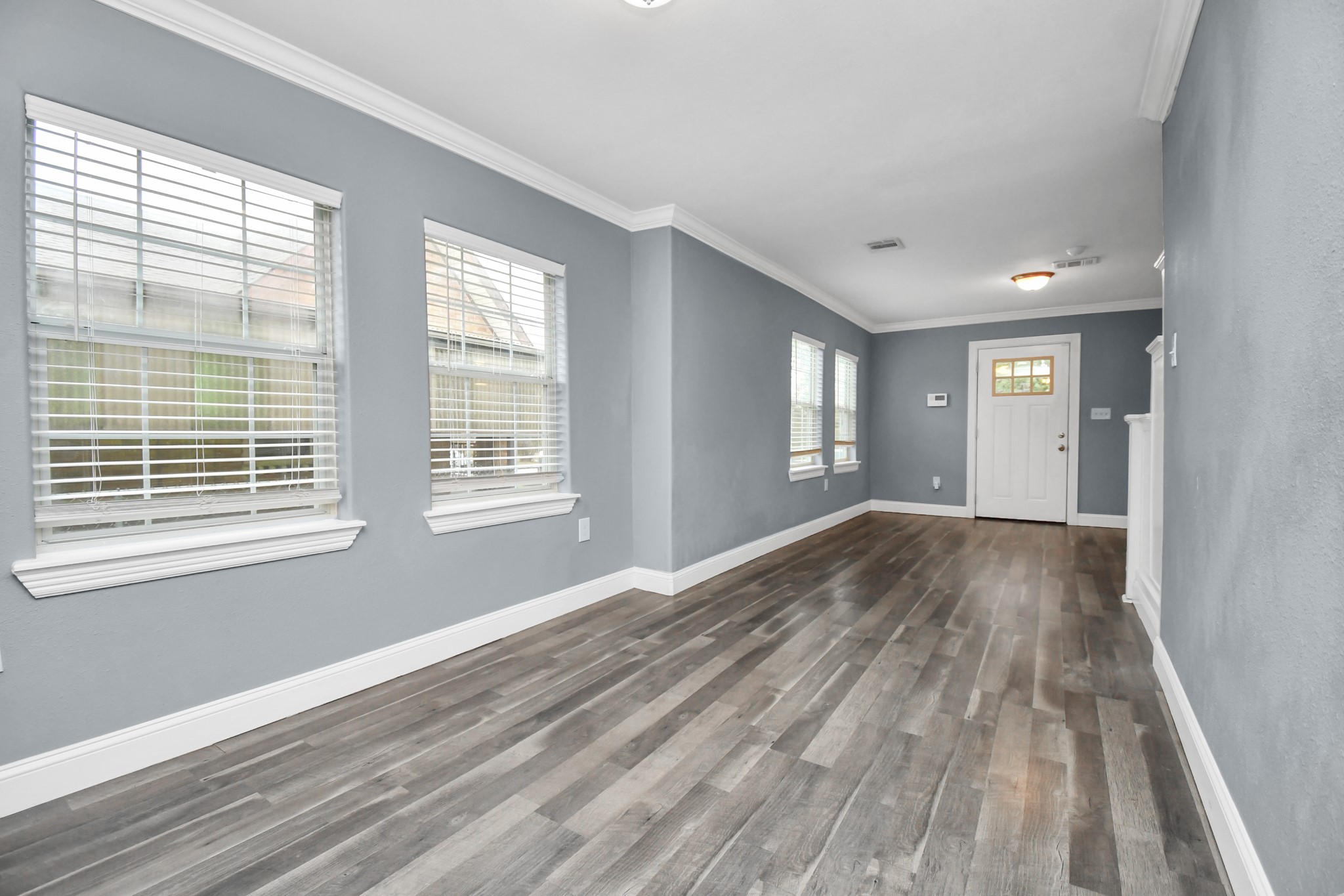 3217 Michigan Street Baytown, TX 77520 - Photo 10 of 37 a view of empty room with wooden floor and fan