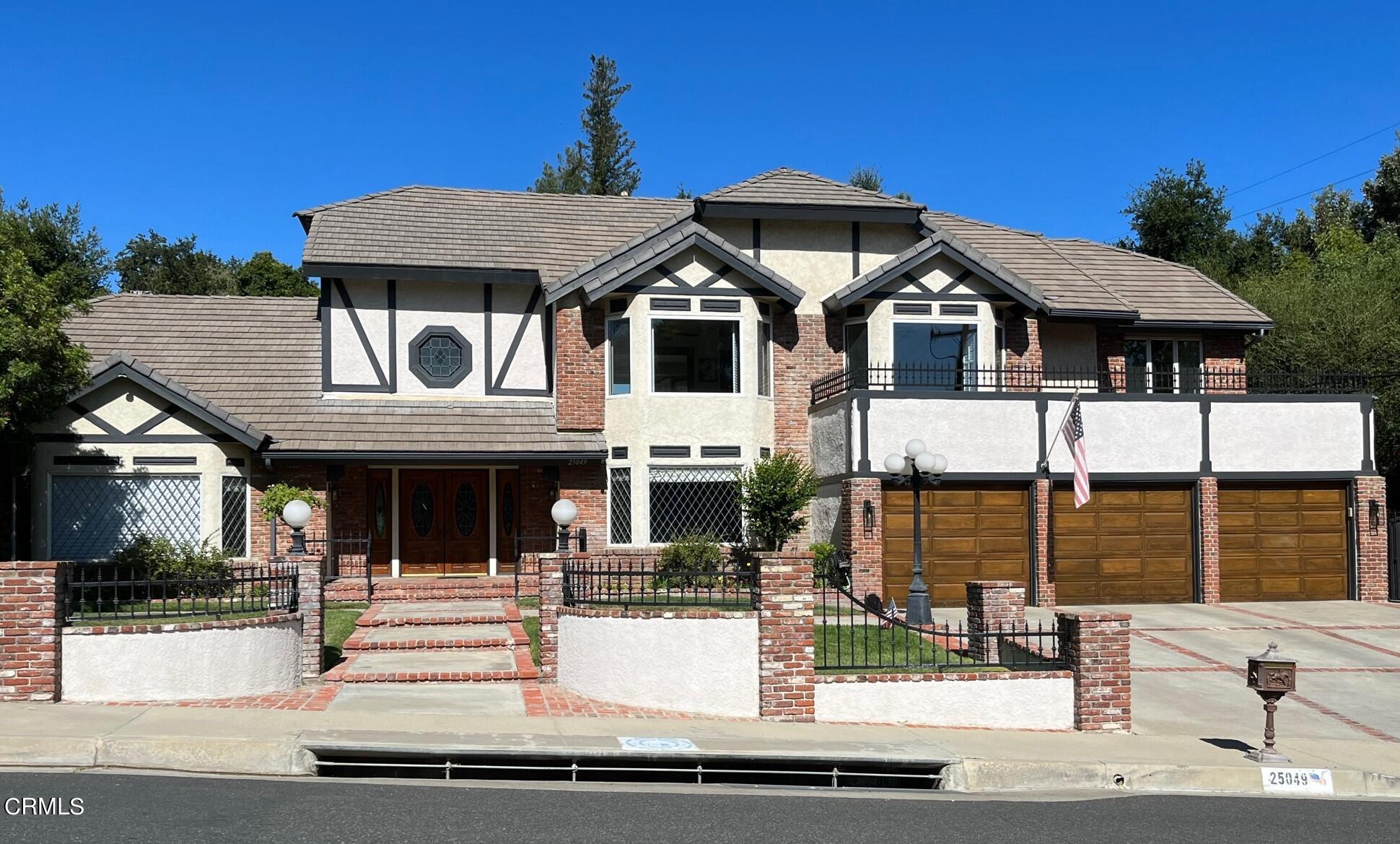 25049 Highspring Avenue Newhall, CA 91321 - Photo 1 of 52 a front view of a house with a porch