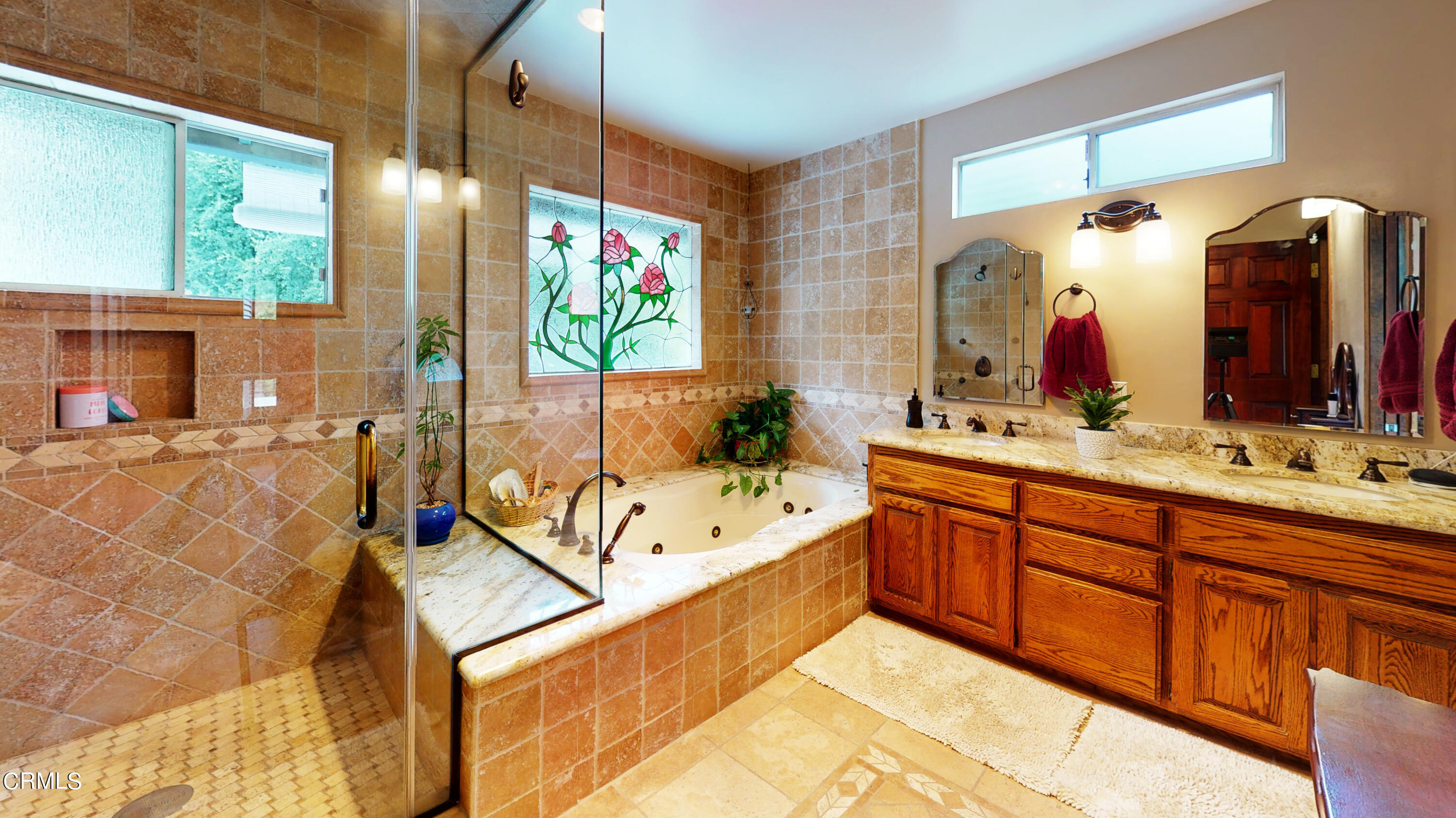 25049 Highspring Avenue Newhall, CA 91321 - Photo 15 of 52 a spacious bathroom with a double vanity sink a mirror and a bathtub