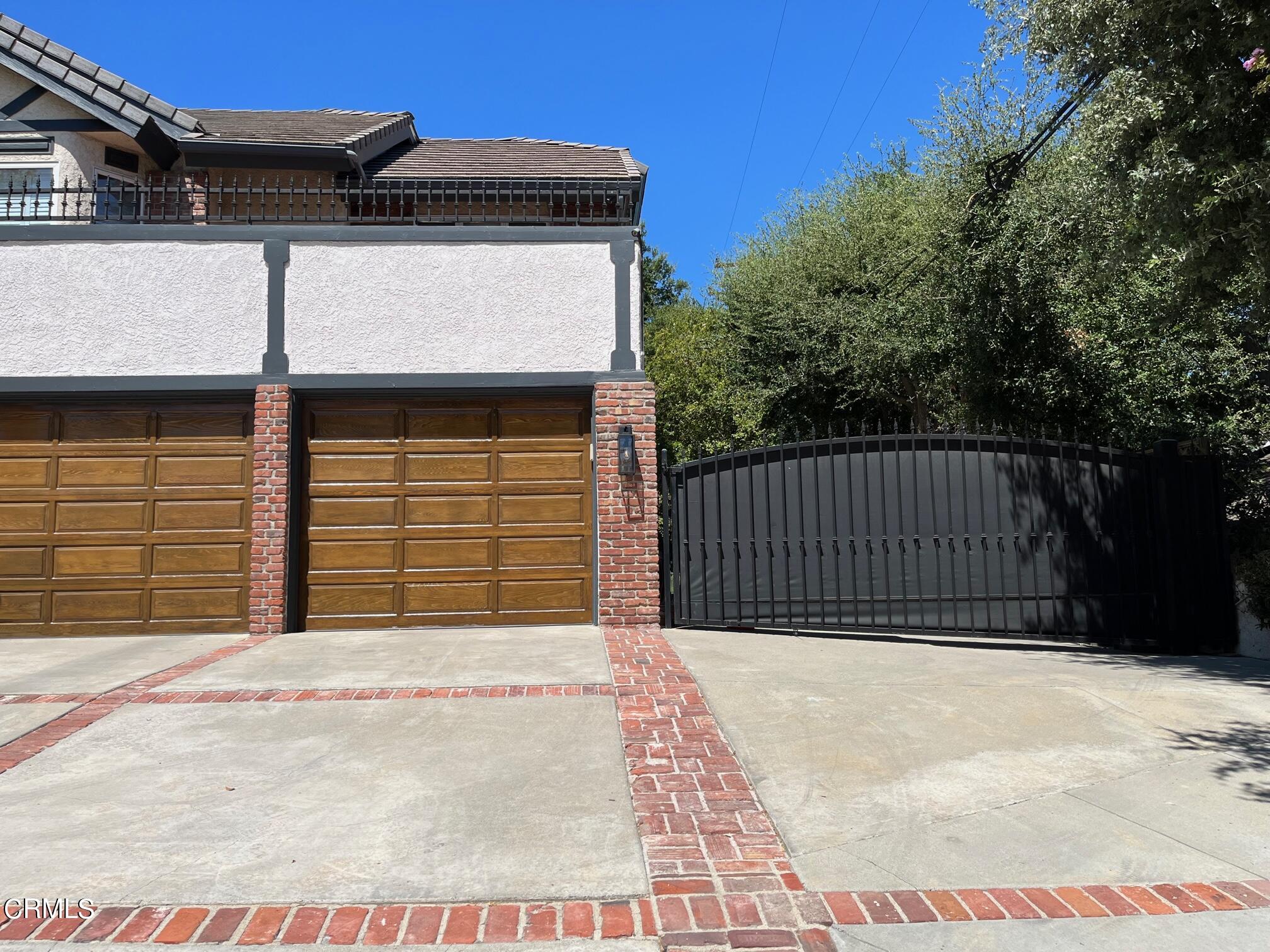 25049 Highspring Avenue Newhall, CA 91321 - Photo 31 of 52 a side view of a house with a garage