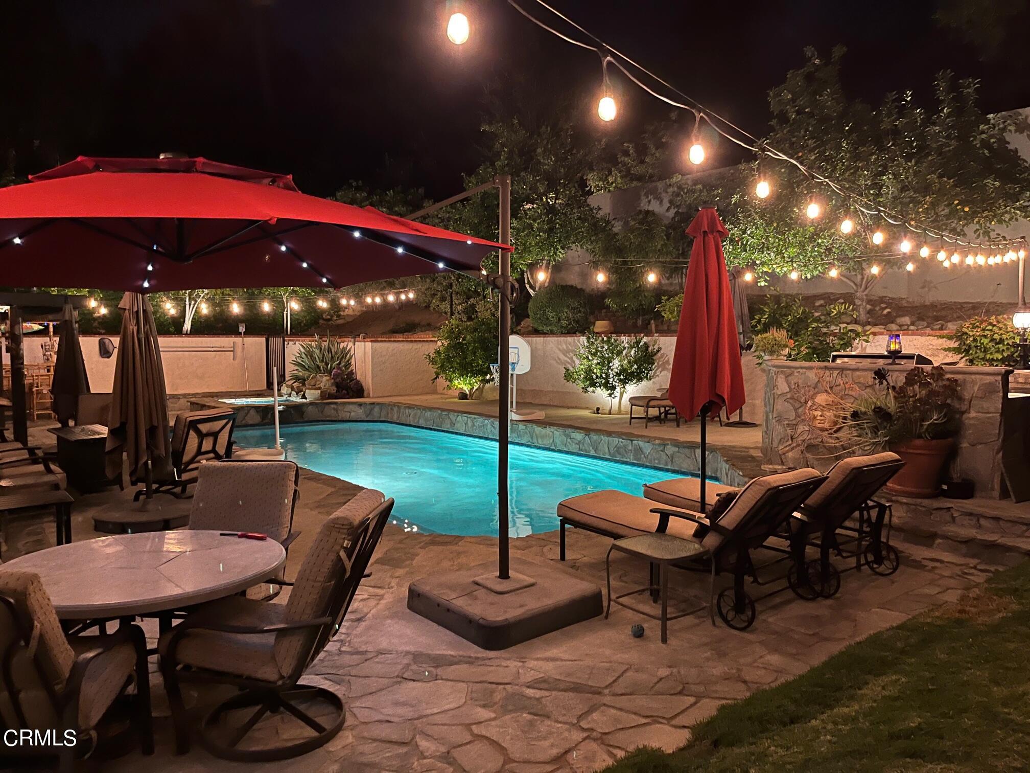25049 Highspring Avenue Newhall, CA 91321 - Photo 46 of 52 a view of a patio with a table and chairs
