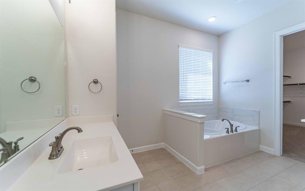 1907 Rondinella Drive Rockwall, TX 75032 - Photo 11 of 21 a bathroom with a tub sink and mirror