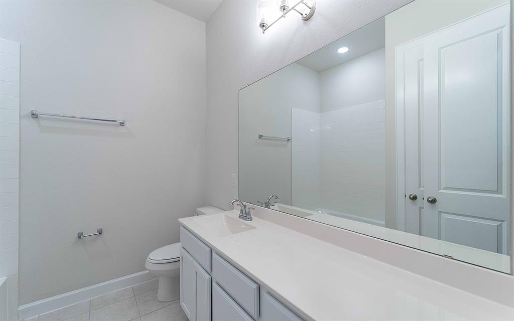 1907 Rondinella Drive Rockwall, TX 75032 - Photo 17 of 21 a bathroom with a sink a toilet and shower