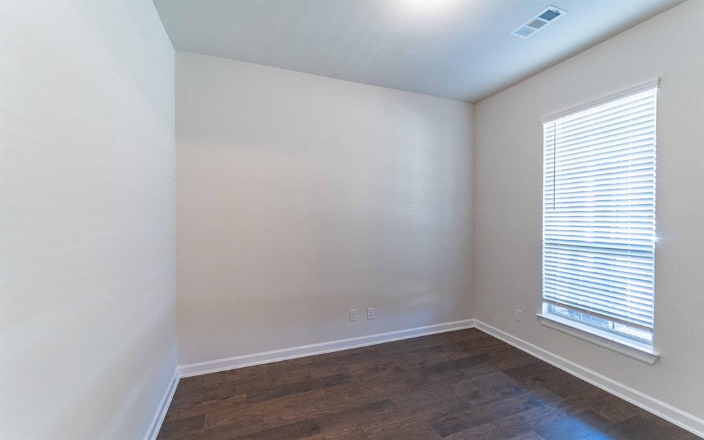 1907 Rondinella Drive Rockwall, TX 75032 - Photo 19 of 21 an empty room with wooden floor and windows