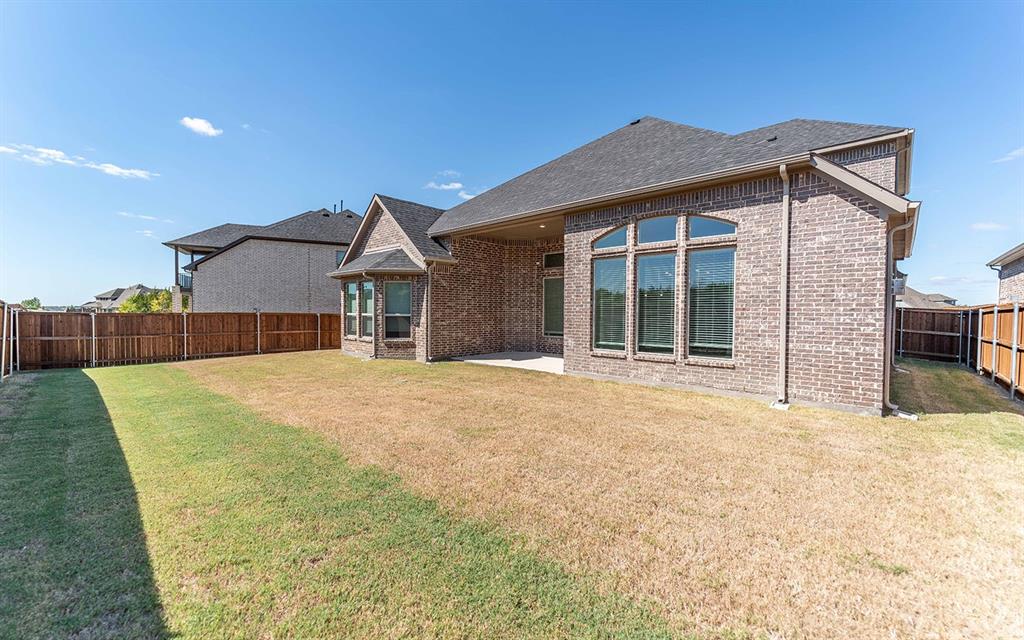 1907 Rondinella Drive Rockwall, TX 75032 - Photo 21 of 21 a view of a house with a yard and wooden fence