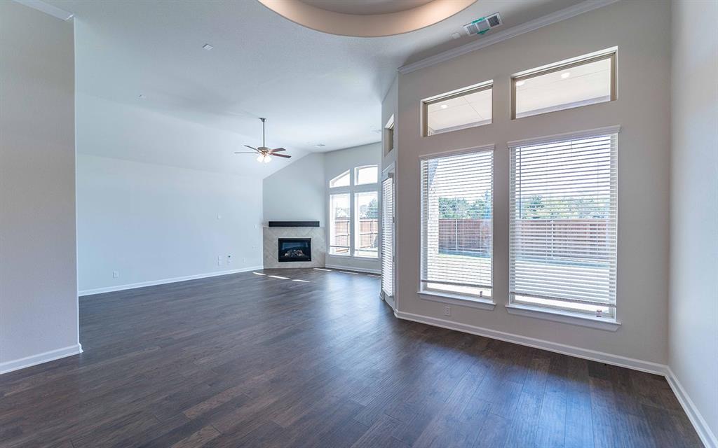 1907 Rondinella Drive Rockwall, TX 75032 - Photo 4 of 21 wooden floor in an empty room with a window