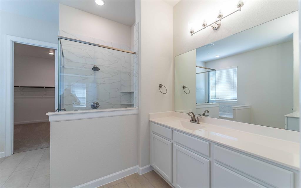 1907 Rondinella Drive Rockwall, TX 75032 - Photo 10 of 21 a bathroom with a sink a mirror and a shower