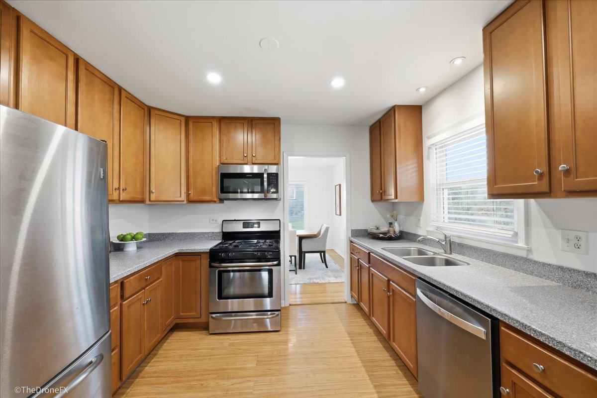 1519 Foothill Drive Wheaton, IL 60189 - Photo 19 of 44 a kitchen with stainless steel appliances granite countertop a stove top oven a refrigerator a sink and dishwasher with wooden floor