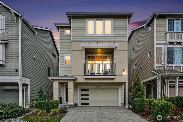a front view of a house with a garage and balcony
