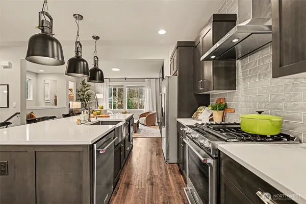 a kitchen with a sink a stove and cabinets