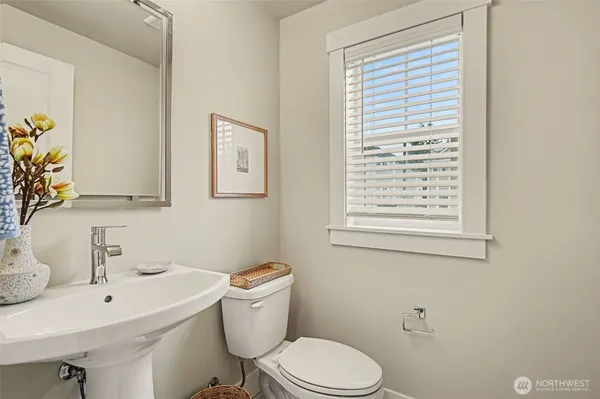 a white toilet sitting next to a bathroom sink