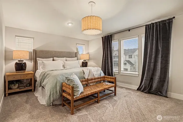 a spacious bedroom with a bed and a chandelier