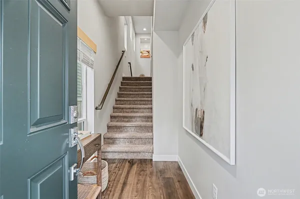 a view of entryway with wooden floor and stairs