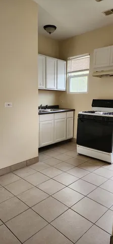 a kitchen with stainless steel appliances a stove a sink and a microwave
