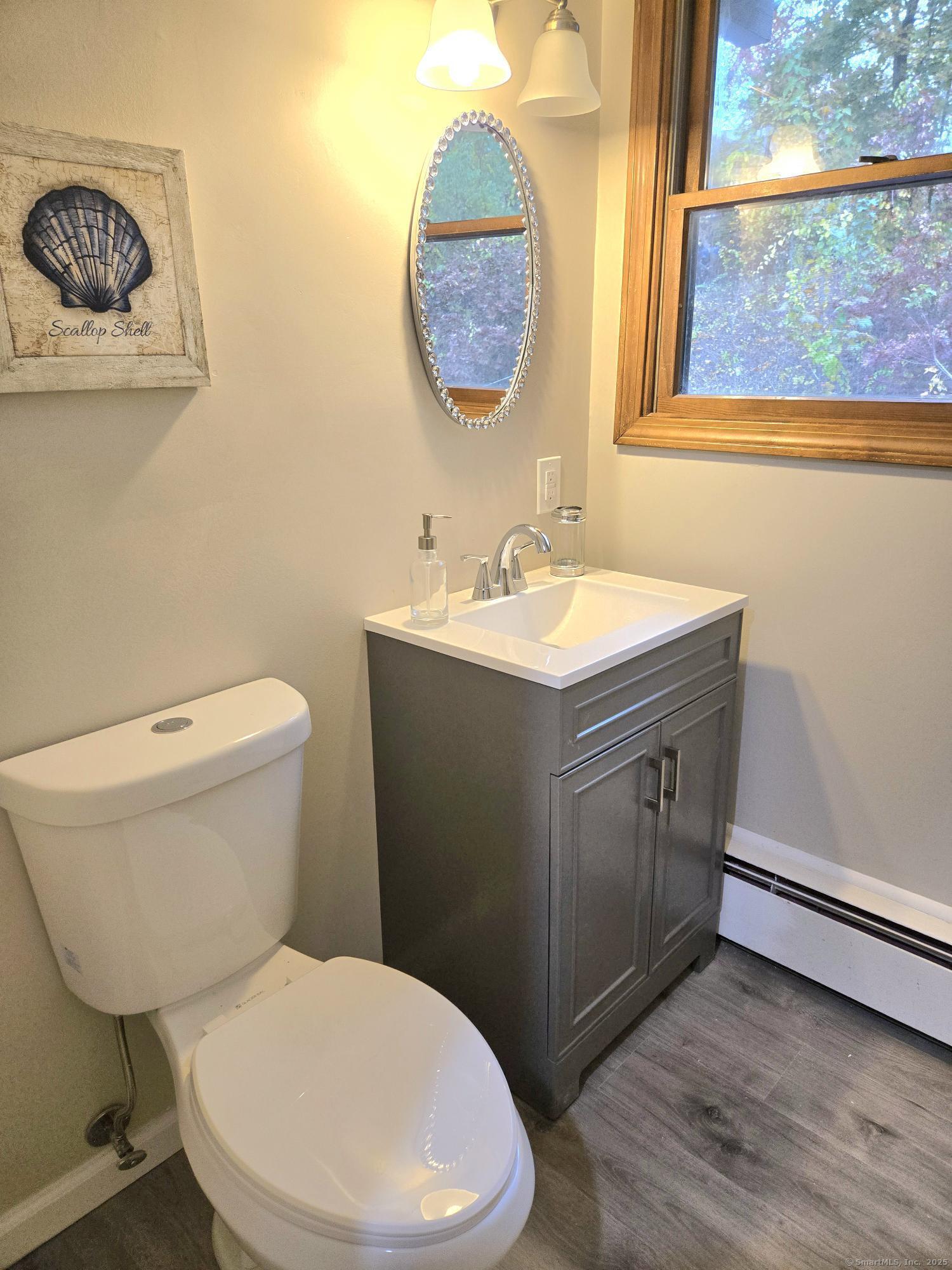 109 Mountain Spring Road Tolland, CT 06084 - Photo 11 of 33 a bathroom with a toilet a sink and a window