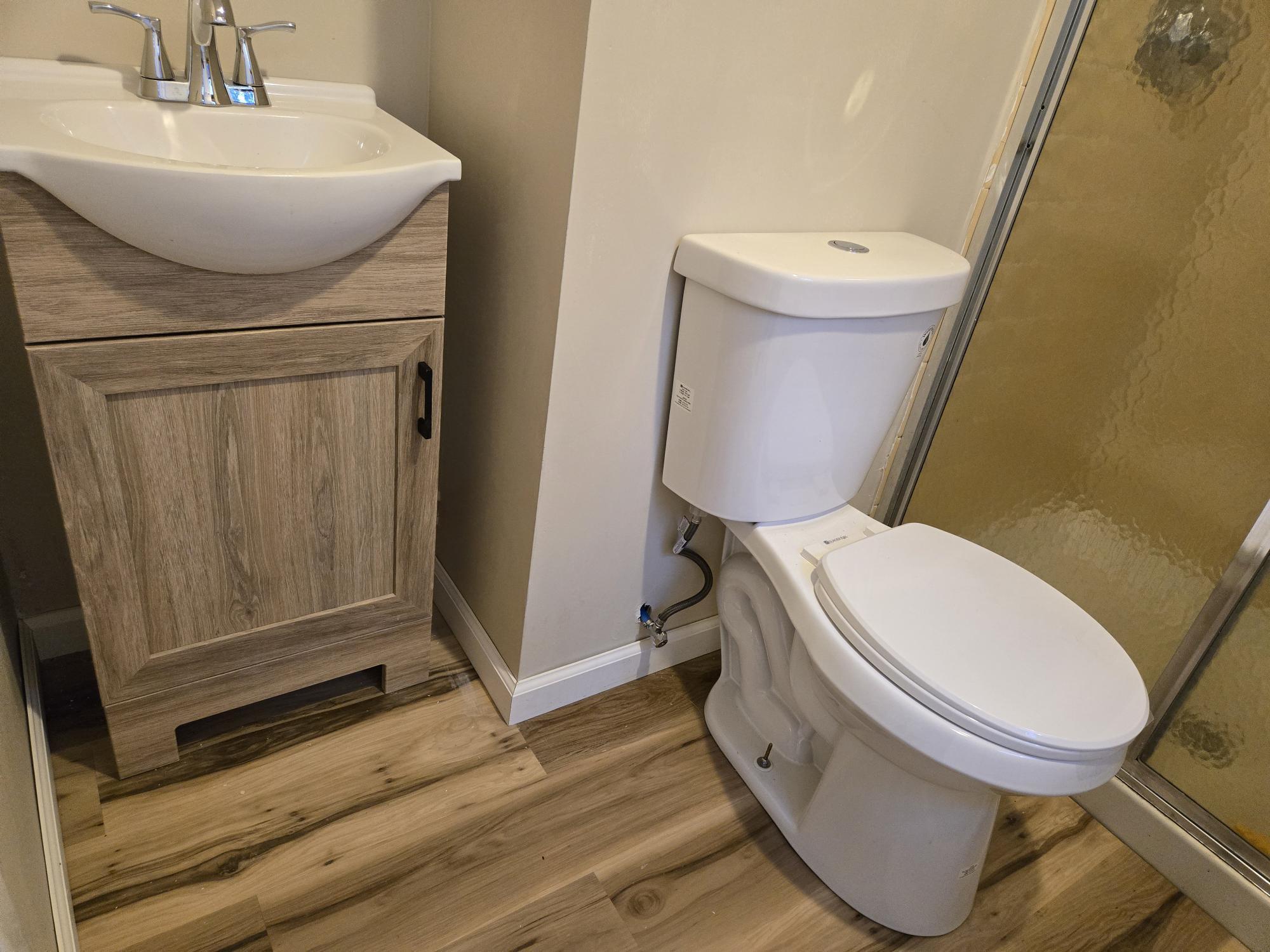 109 Mountain Spring Road Tolland, CT 06084 - Photo 23 of 33 a white toilet sitting next to a bathroom sink