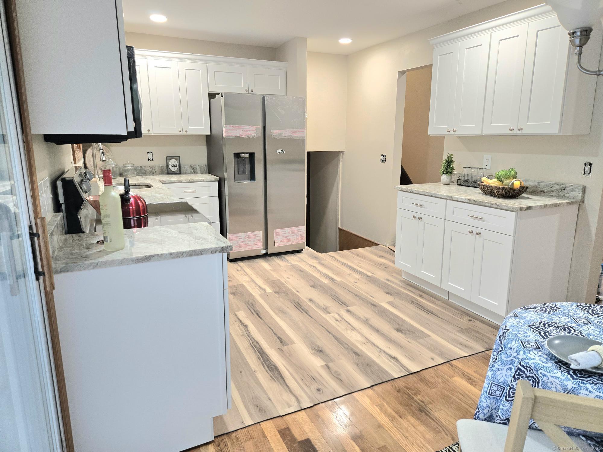 109 Mountain Spring Road Tolland, CT 06084 - Photo 5 of 33 a kitchen with refrigerator and microwave