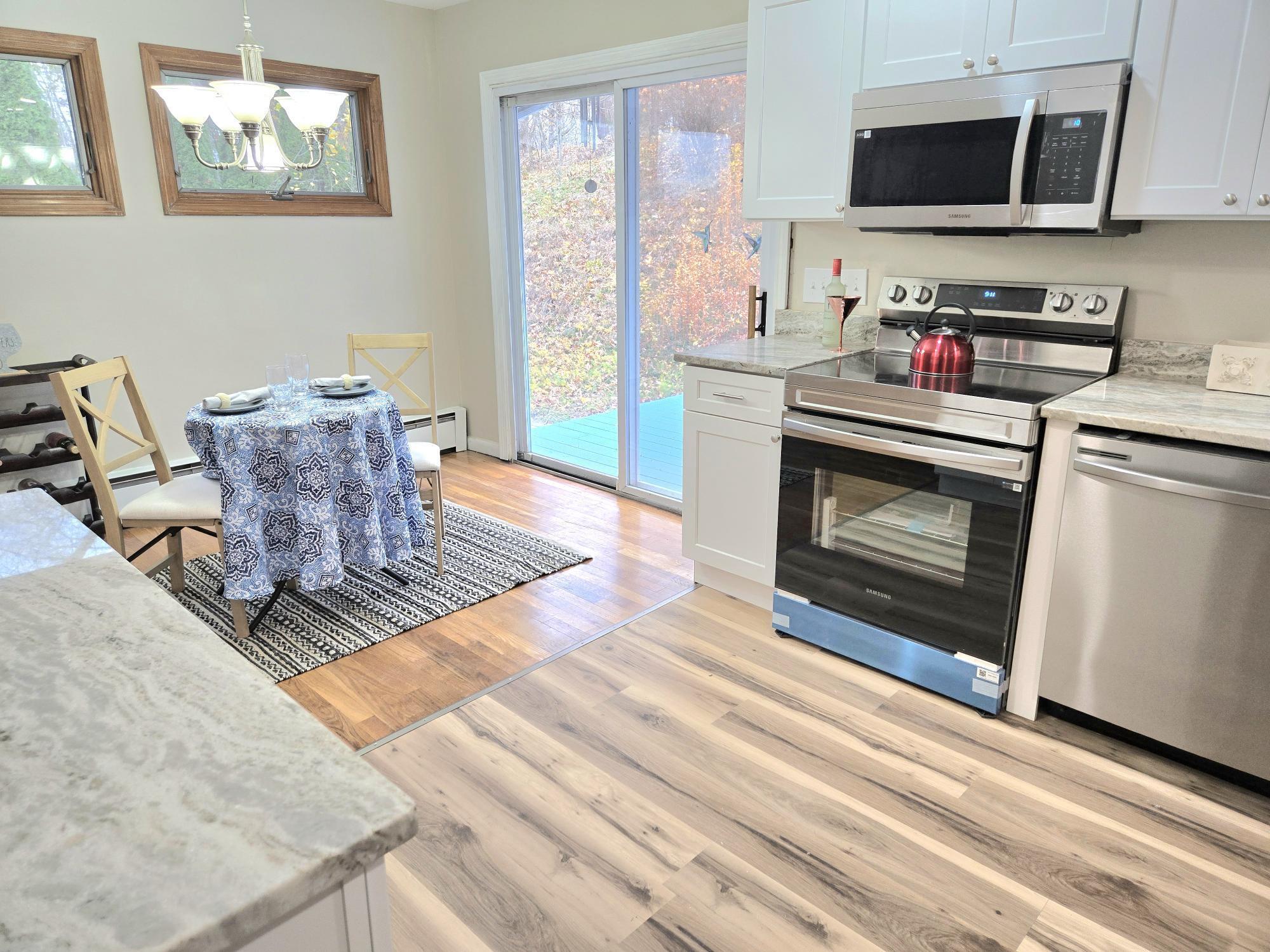 109 Mountain Spring Road Tolland, CT 06084 - Photo 6 of 33 a living room with stainless steel appliances furniture a fireplace and a flat screen tv