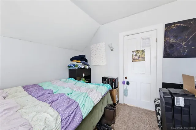 a bedroom with a bed and a table in it