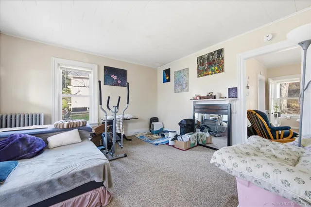 a bedroom with furniture a bed and gym equipment