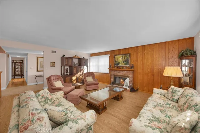 a living room with furniture a fireplace and a table