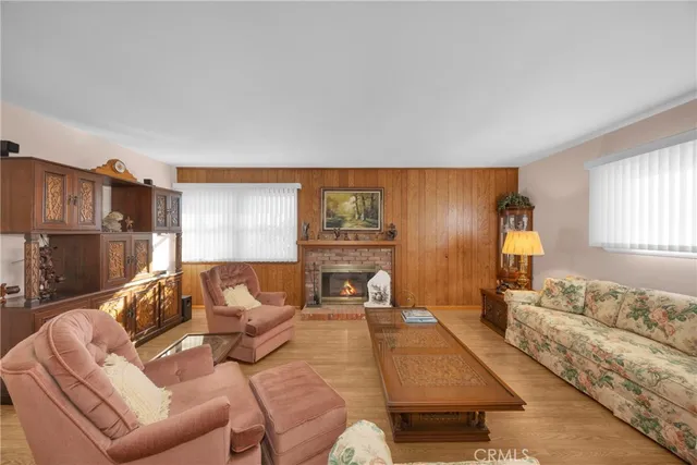 a dining room with furniture a chandelier and wooden floor