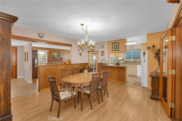 a living room with furniture a flat screen tv and a floor to ceiling window