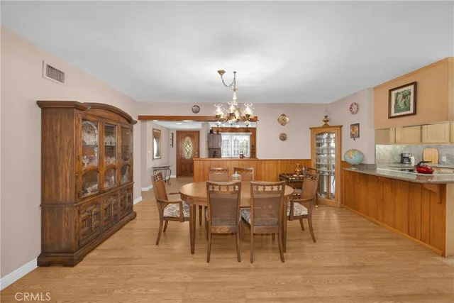 a living room with furniture wooden floor and a large window
