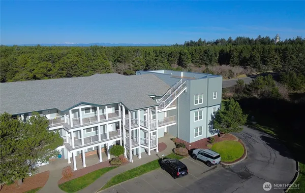an aerial view of a house with a yard and seating space
