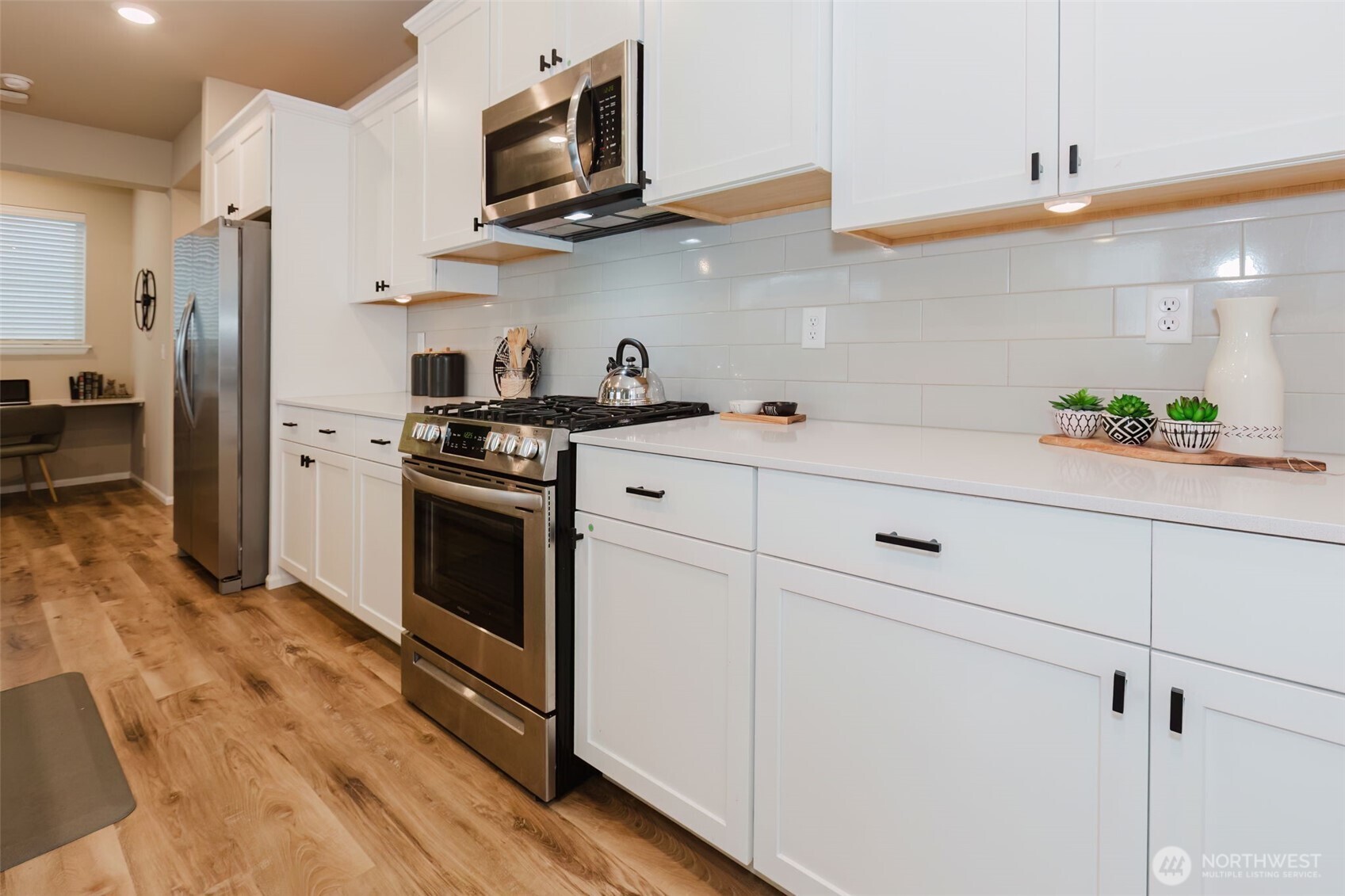 916 Baker Heights Loop Bremerton, WA 98312 - Photo 11 of 40 a kitchen with stainless steel appliances white cabinets and a refrigerator