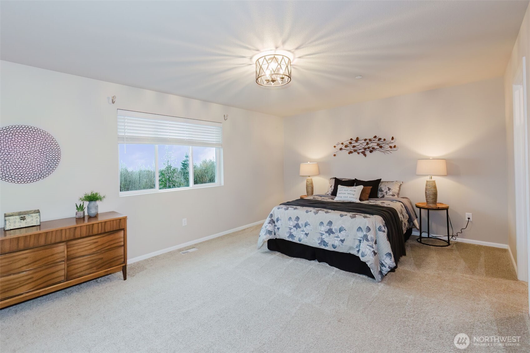 916 Baker Heights Loop Bremerton, WA 98312 - Photo 21 of 40 a bedroom with a large bed and a chandelier